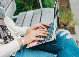 The Rise of Backpage Alternatives: How Dating Platforms Have Evolved person in white long sleeve shirt and blue denim jeans using macbook pro