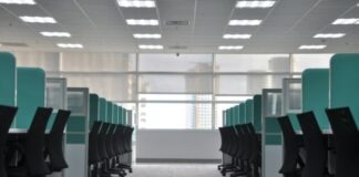 empty black rolling chairs at cubicles