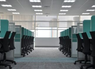empty black rolling chairs at cubicles