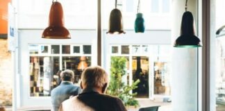 man in chair with table beside coffee