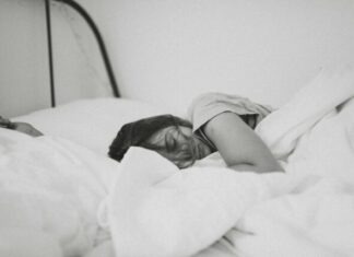 Understanding the Risks of Sleep Apnea grayscale photo of sleeping woman lying on bed