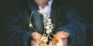 man holding incandescent bulb
