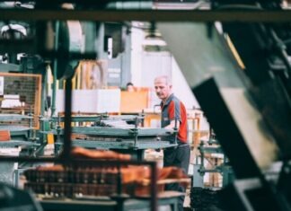Why Should Manufacturers Care About PR and Marketing? man in orange polo shirt standing in front of table