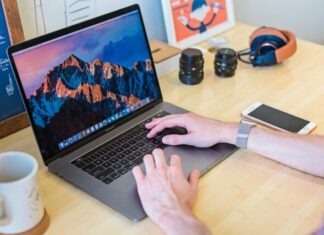 11 Ways to Declutter Your Digital Space MacBook Pro turned on beside white ceramic mug