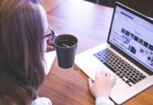 Guide to Direct Order from Taobao woman holding tea filled mug using MacBook