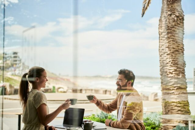 Photo by DocuSign man in brown jacket sitting beside with woman at coffee shop