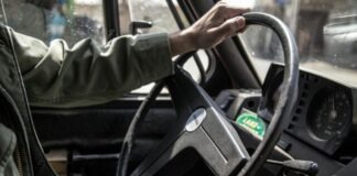 person holding black steering wheel
