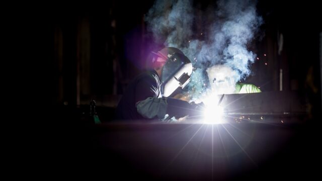 Photo by Pete Wright person welding metal using gray helmet