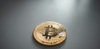 gold round coin on gray surface