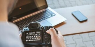 person holding black DSLR camera
