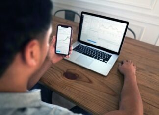 Investor’s Alchemy: Turning Market Research into Gold person holding iphone 6 near macbook pro