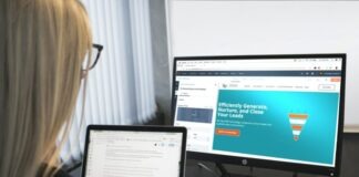 woman sitting in front of turned-on computer monitor
