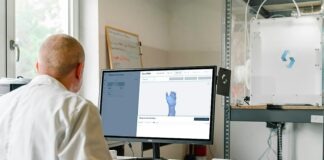 man in white dress shirt sitting in front of computer