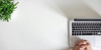 person wearing watch near laptop
