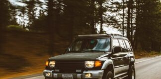 timelapse photography of green SUV on road