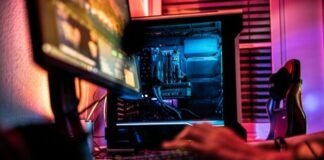 a person sitting in front of a computer monitor