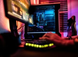 a person sitting in front of a computer monitor