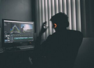 Top 5 Video Upscalers: Insights & Inputs shallow focus photography of man listing to music in front of the computer