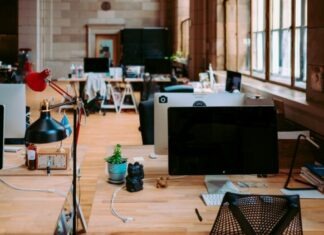 black flat screen computer monitor on brown wooden table