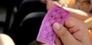 a person holding a pink ticket in their hand