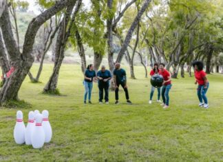 Party in Style: Custom Bowling Shirts for Your Next Event Free People Standing on Green Grass Field Playing Bowling Stock Photo
