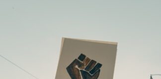 person holding brown wooden frame