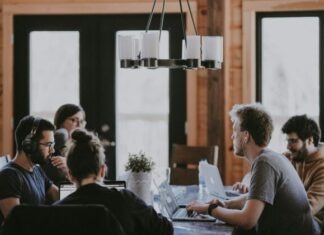 The Ultimate Guide to Effective Employee Onboarding Practices sittin people beside table inside room