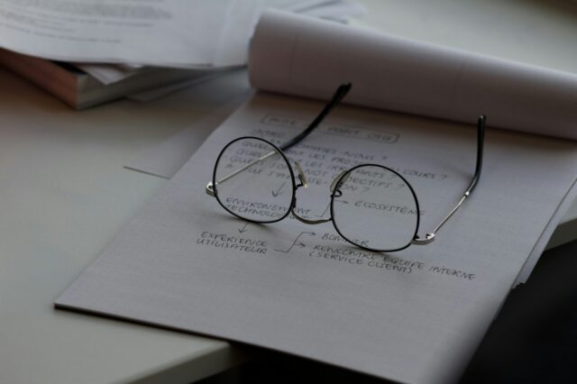 Photo by rivage black framed eyeglasses on top of white printing paper