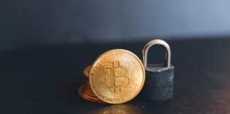 a bit coin sitting on top of a padlock