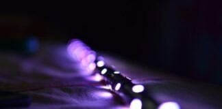 a close up of a string of lights on a bed