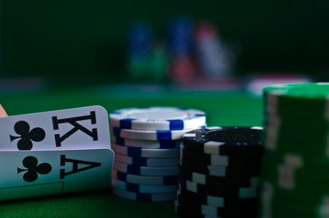 Photo by Michał Parzuchowski white and black dice on green table