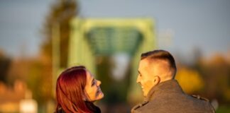 man and woman standing side by side during daytime