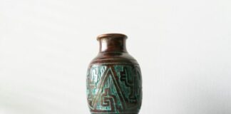 a glass vase with a blue and green design