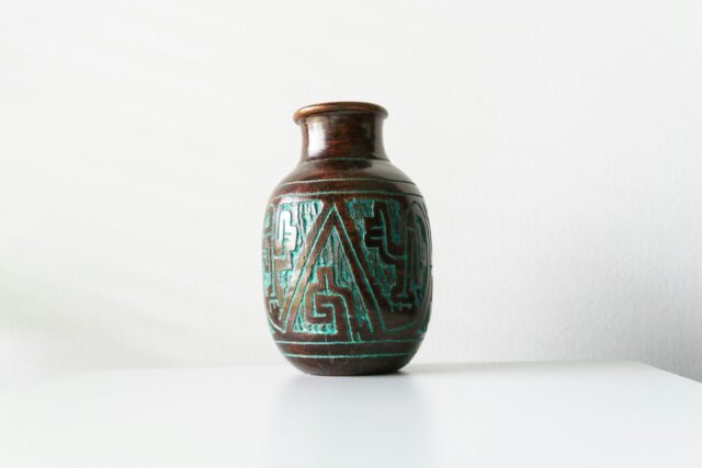 Photo by Carlos Felipe Ramírez Mesa a glass vase with a blue and green design