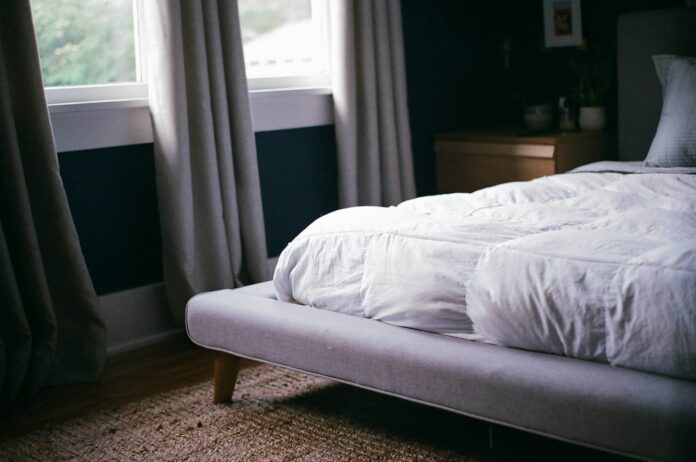 Photo by Ty Carlson white bed by the window during daytime