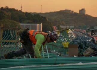 When to Get A Work Injury Lawyer: A Comprehensive Guide man on green galvanized iron sheet holding green bar
