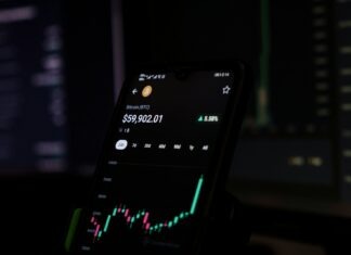 Learn Market Trading: A Beginner’s Guide a cell phone displaying a stock chart on the screen