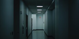 a long hallway with a light at the end of it