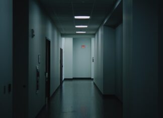 a long hallway with a light at the end of it