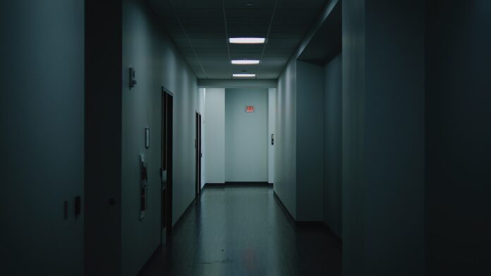 Photo by Leiada Krozjhen a long hallway with a light at the end of it