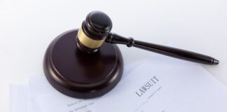 Closeup shot of the judge's gavel on a document of the lawsuit