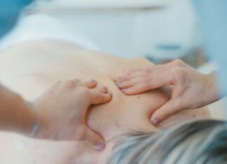 Why Accurate Documentation is Crucial for Your Back Injury Claim in Australia person massaging the back of a woman