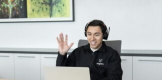 a man wearing headphones sitting in front of a laptop computer