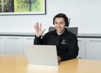 The Importance of Digital Customer Care in Today’s Business Landscape a man wearing headphones sitting in front of a laptop computer