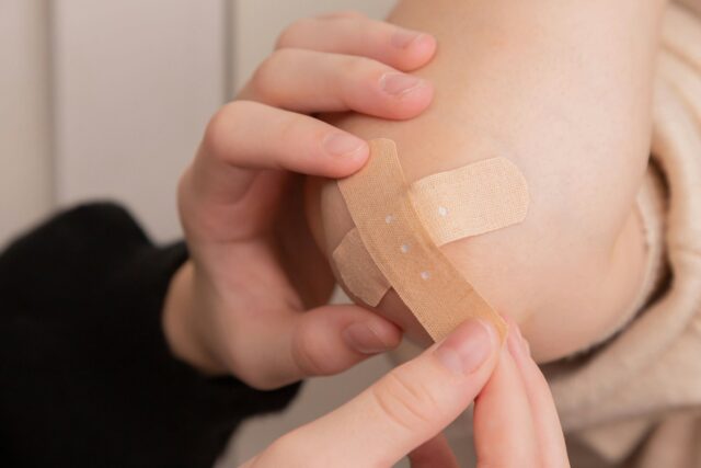Photo by Diana Polekhina person holding band aid on left hand
