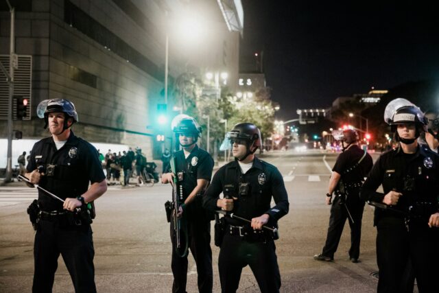 Photo by Sean Lee man in black shirt and pants holding black dslr camera