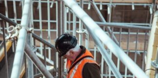 man standing under scaffoldings