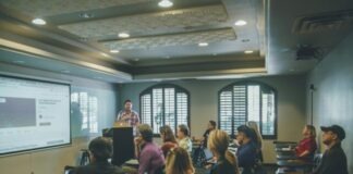 a group of people in a room with a projector screen
