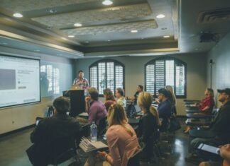 Why Remote Proctoring Excels in Modern Educational Settings a group of people in a room with a projector screen