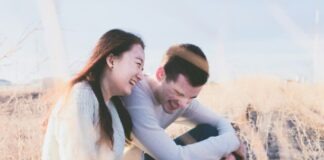 photo of man and woman laughing during daytime